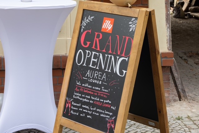 Chalkboard announcing the opening of Auréa Lounge